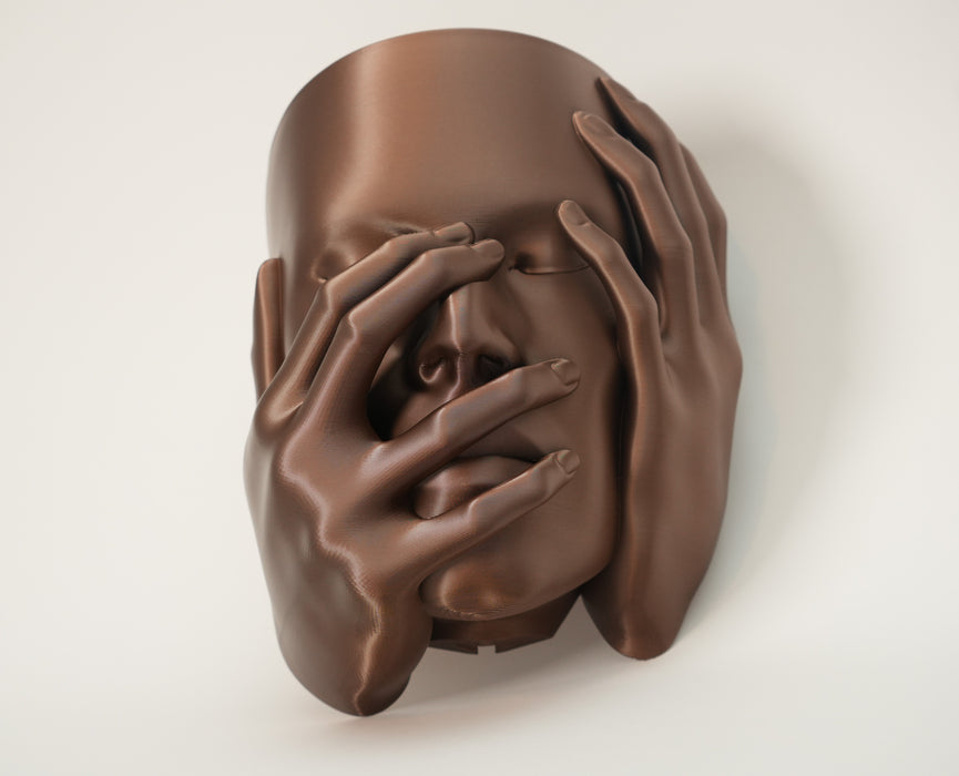 Echo wall planter in warm brown finish with sculptural face and hands covering the eyes