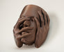 Close front view of Echo wall planter with expressive hand details and face sculpture