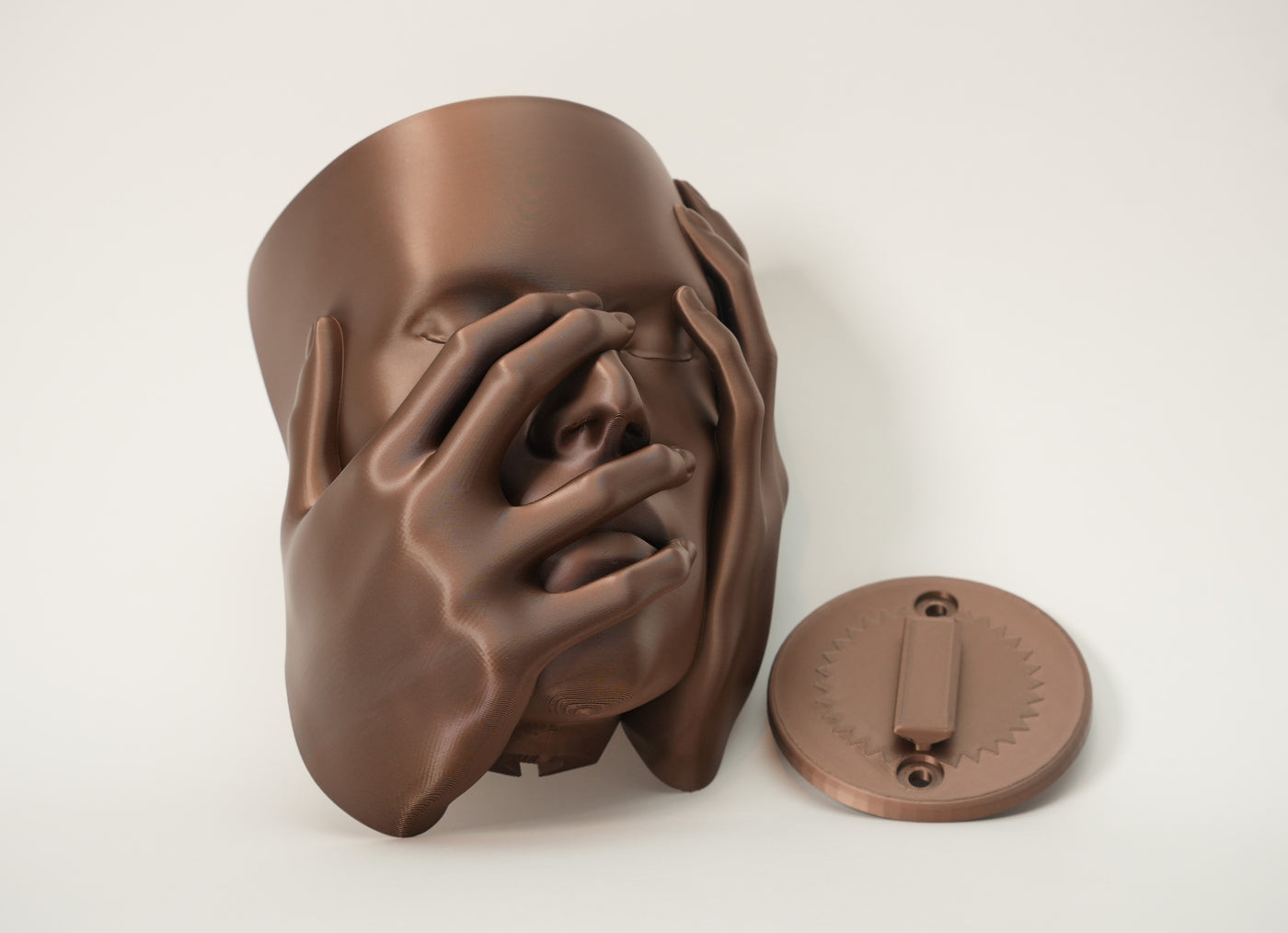 Echo 3D printed wall planter with matching round mounting plate shown beside sculptural face planter