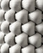 Close-up of white 3D printed planter surface, showing highly detailed interlaced texture with concave diamond-shaped units creating a dynamic shadow play; the filament lines highlight precision printing, and the tactile quality of the thick braided design is clearly visible.