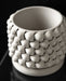 Angled top view of a 3D printed white planter with thick, curved wall structure and intricate repeating braided pattern; open interior emphasizes functional depth and clean print finish inside the rim.