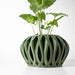 Stylish sculptural planter featuring symmetrical openings and a bulbous base, ideal for interior design
