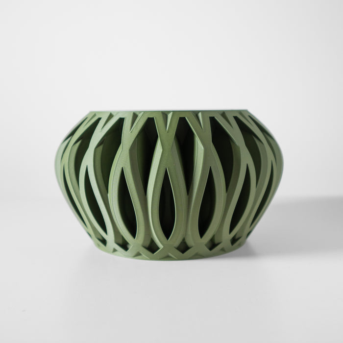 Minimalist tabletop pot with airy cutout pattern and curved shape, futuristic home decor accent