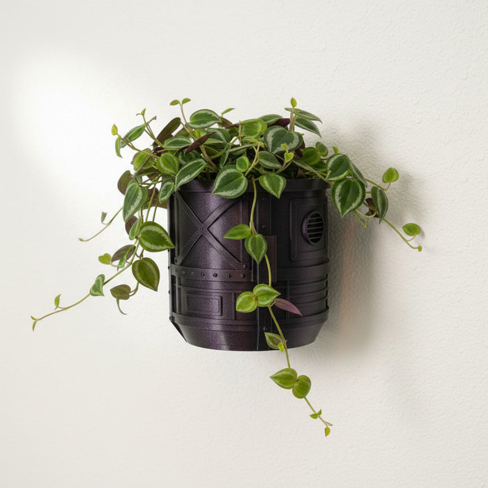 Mech Pod wall planter in Galaxy Fuchsia mounted on wall with trailing plant and industrial sci-fi texture