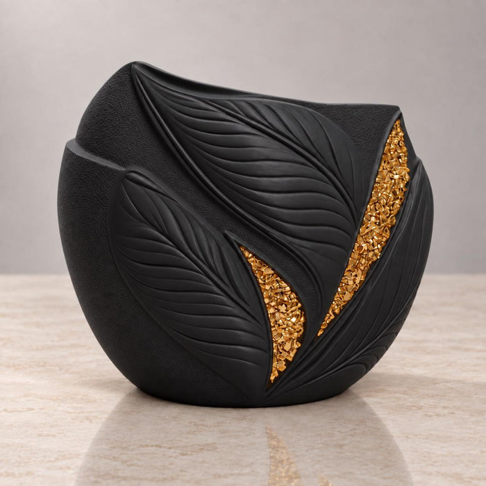 Angled view of Aurelia black planter showing raised leaf veins and gold accents