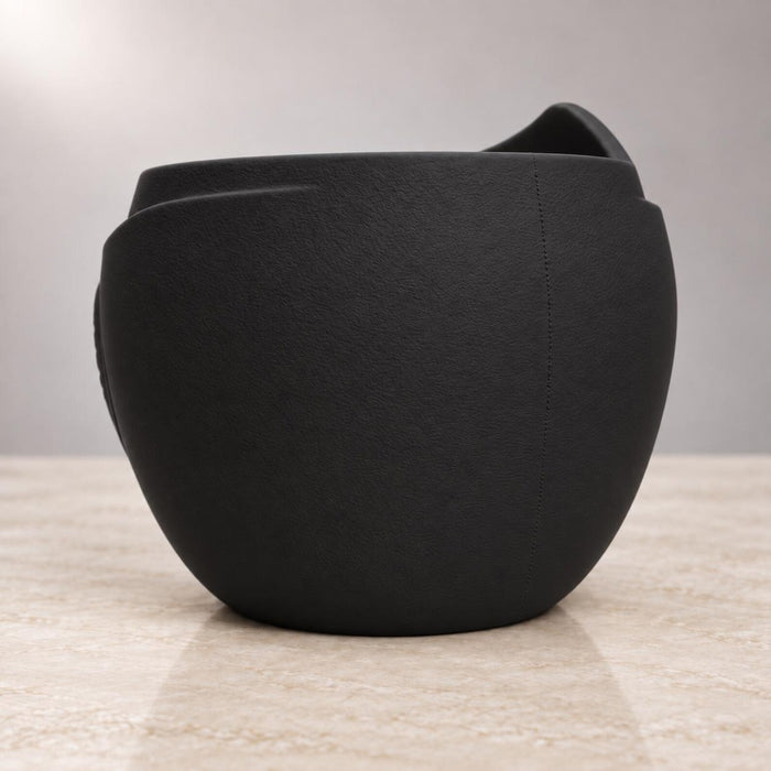 Back view of Aurelia black planter showing its rounded textured body
