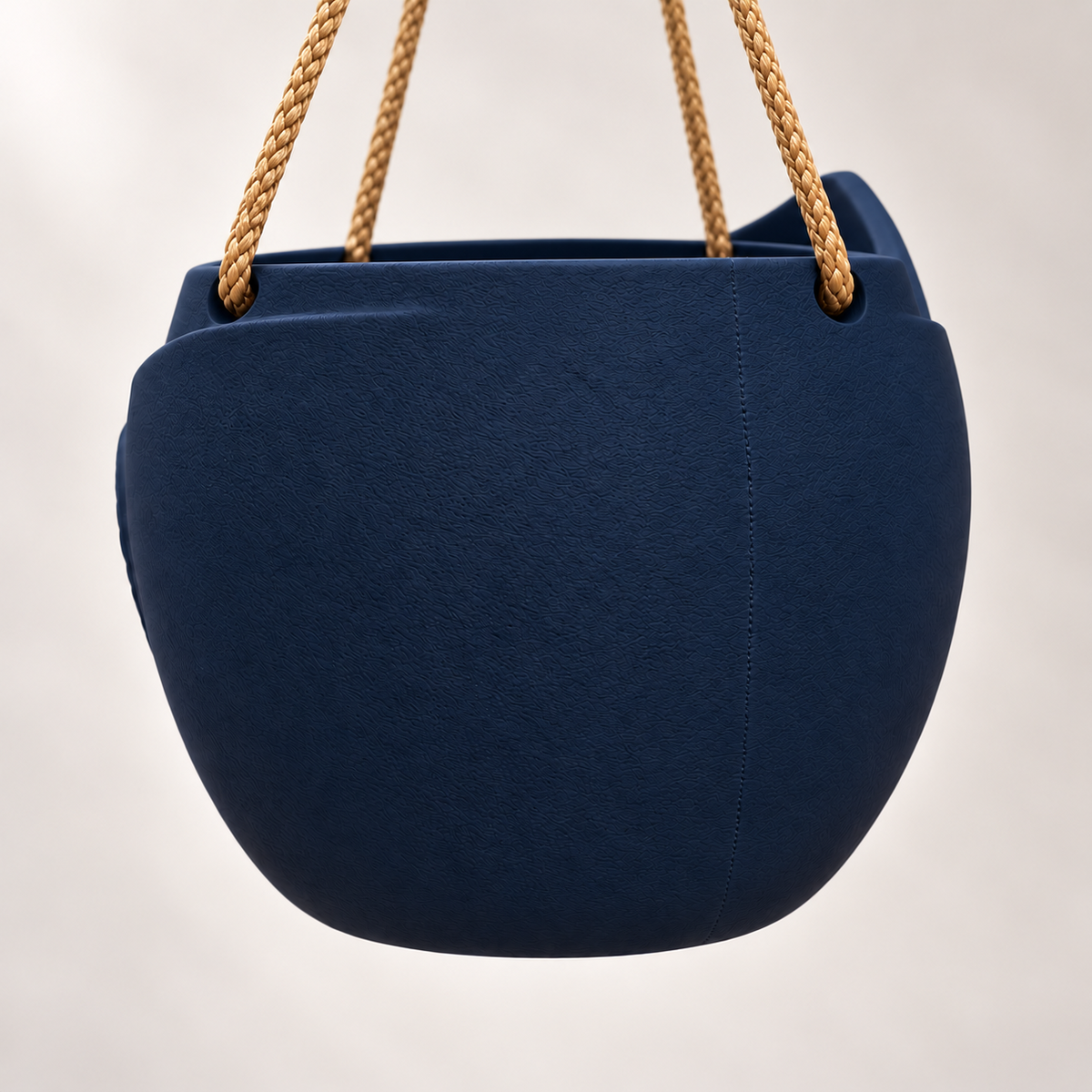 Back of the navy Aurelia hanging planter with a rounded textured body and tan suspension ropes.