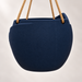 Back of the navy Aurelia hanging planter with a rounded textured body and tan suspension ropes.
