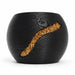 Side view of the rounded black planter, showing fine diagonal ridges and the end of the gold-tone inlay