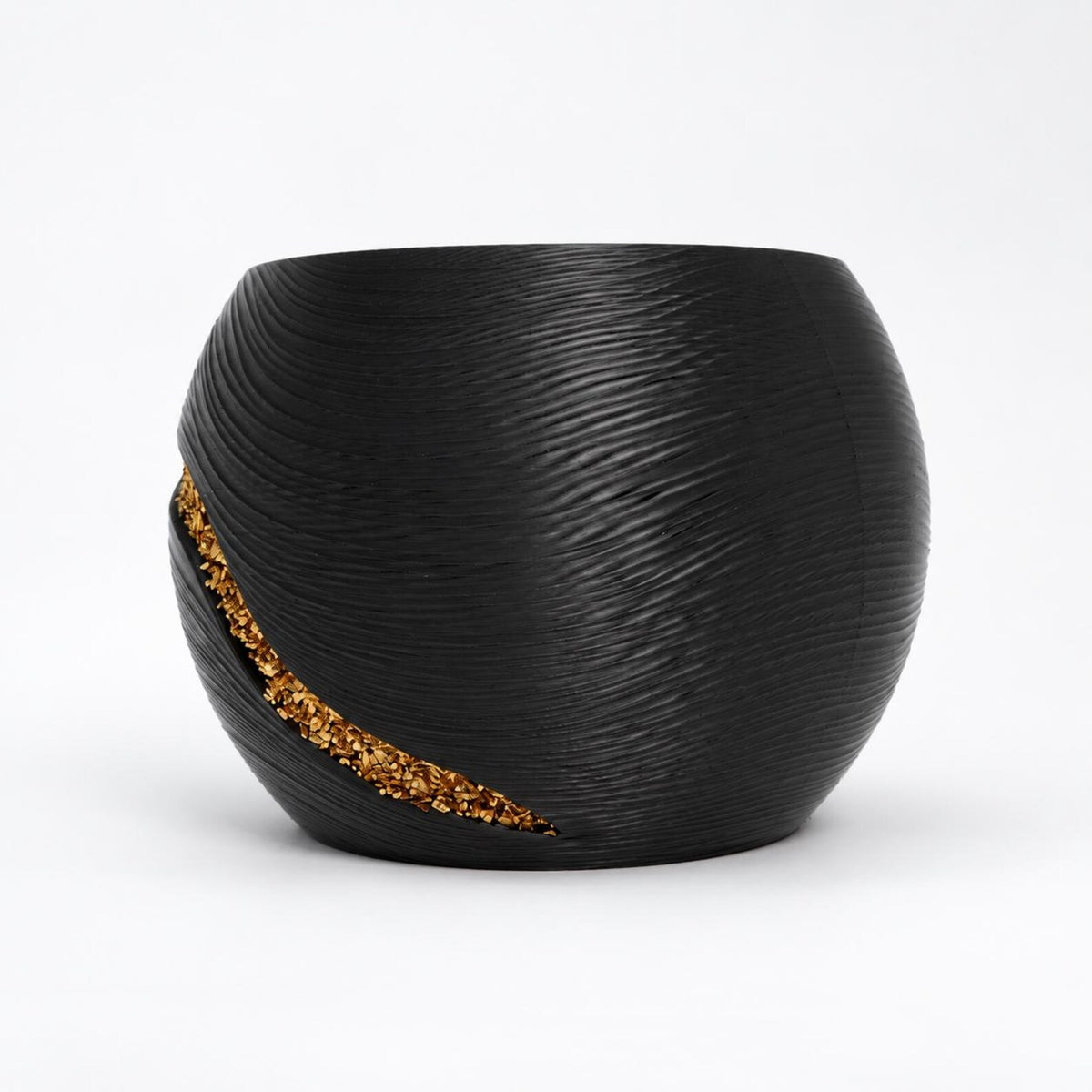 Reverse view of the black planter with a shorter curved gold-tone chip accent in the textured surface