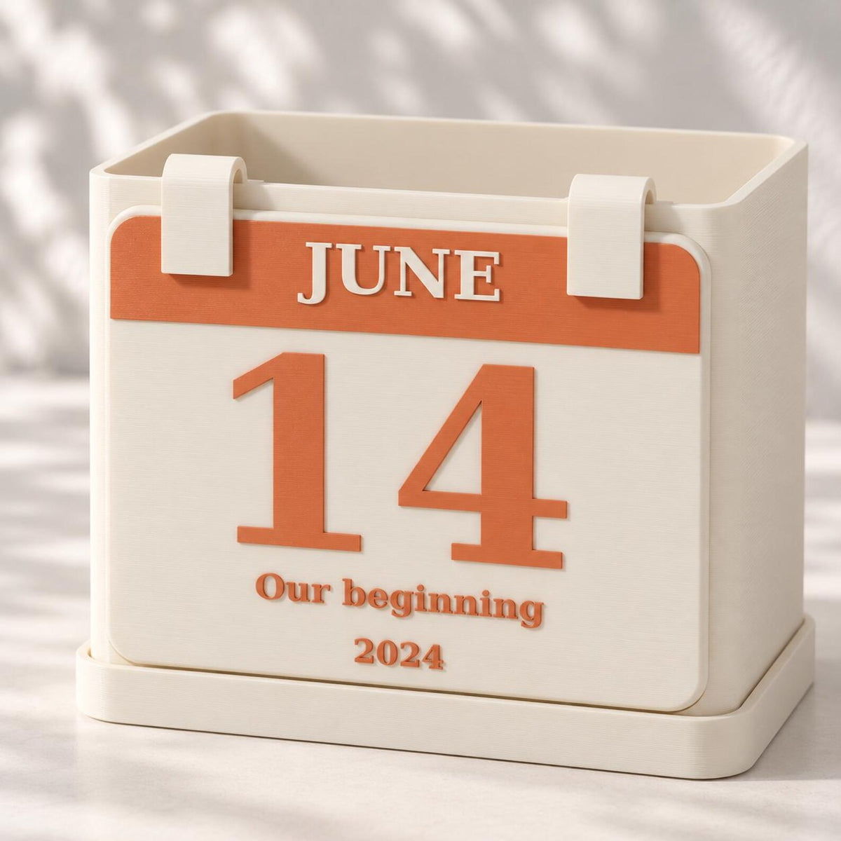 Cream calendar planter with a raised June 14 plaque, personalized caption and matching drainage tray.