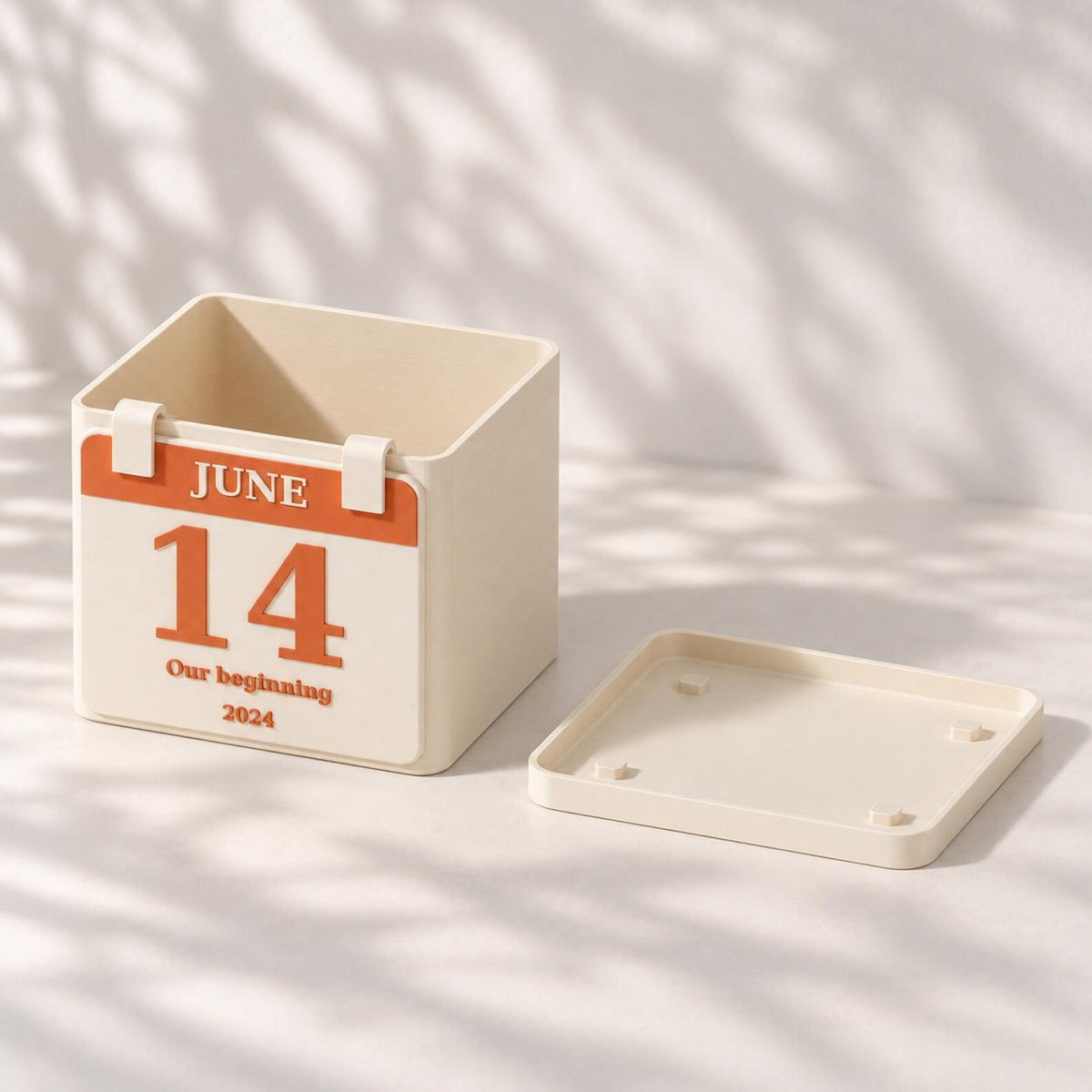 Angled view of the personalized calendar planter beside its removable matching drainage tray.