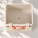 Top view inside the rectangular planter showing its centered drainage hole and personalized front plaque.