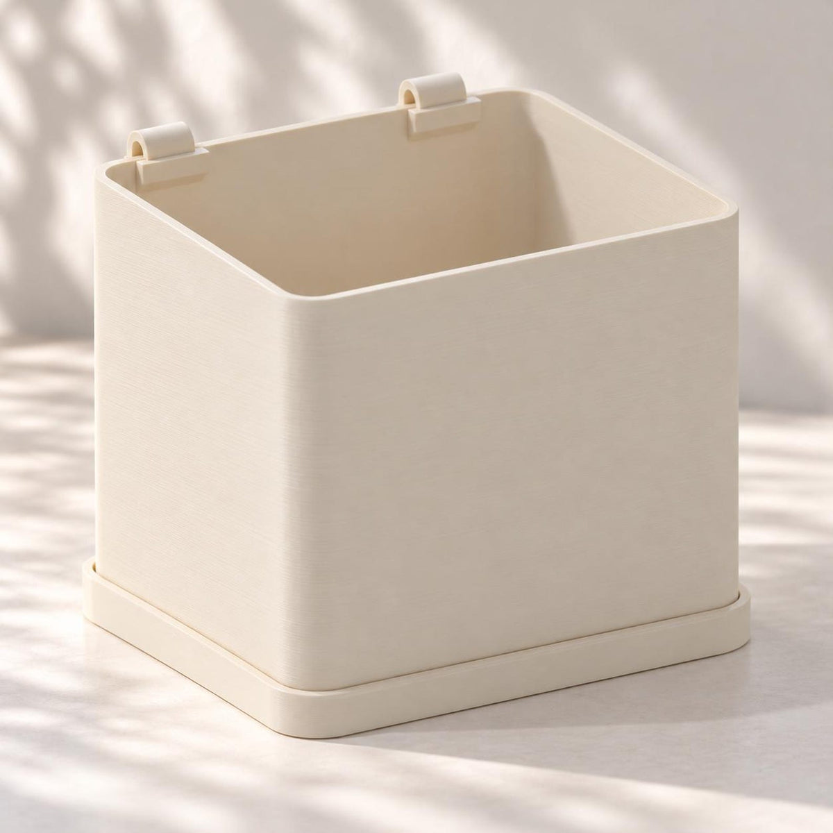 Rear view of a cream rectangular calendar planter with rounded corners and a matching tray.