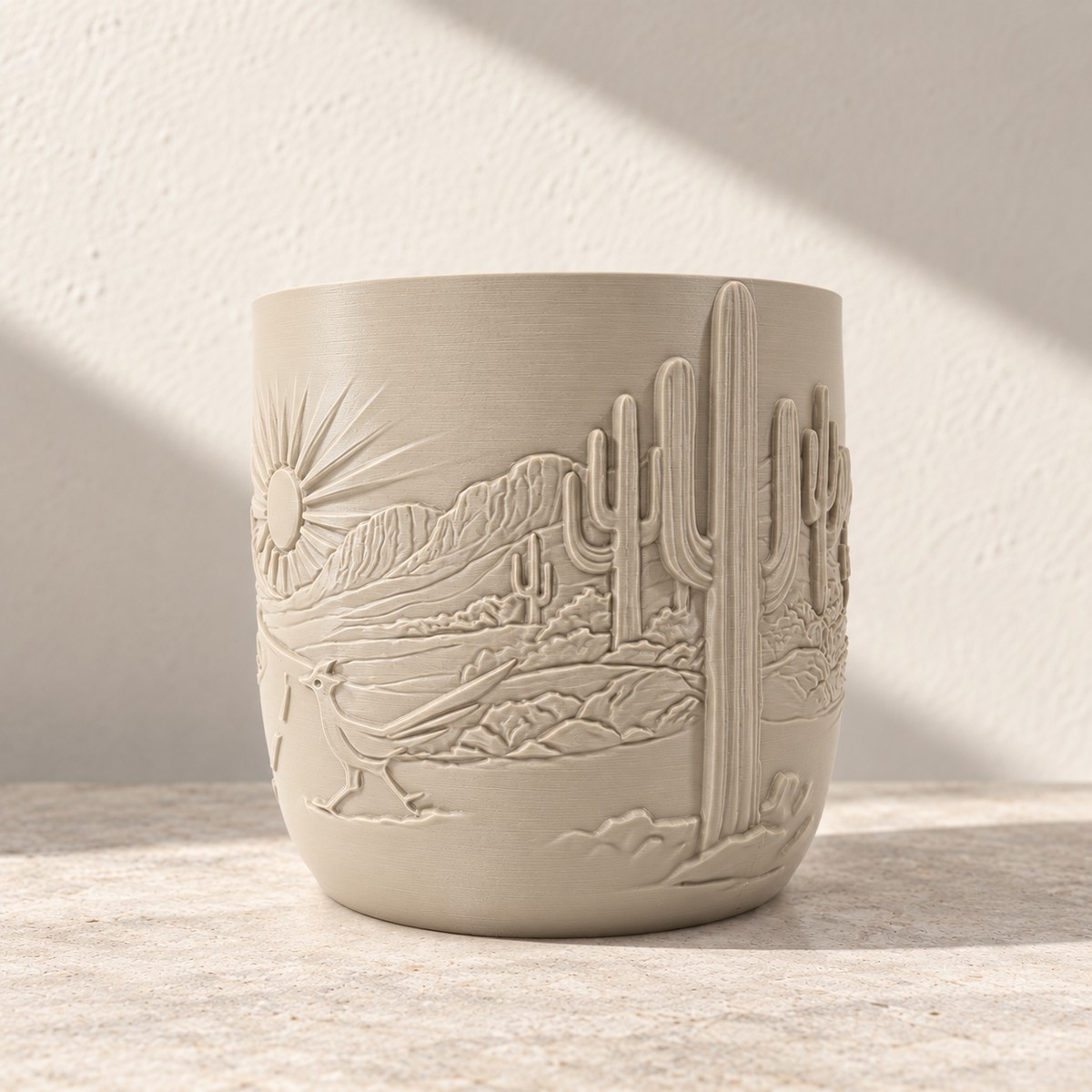 Side of the cream Desert Sunrise planter showing tall cactus relief beside the continuing landscape scene.