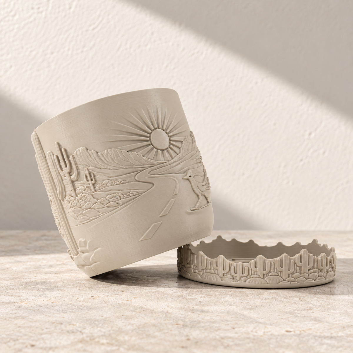 Cream Desert Sunrise planter tipped beside its separate cactus-patterned tray.