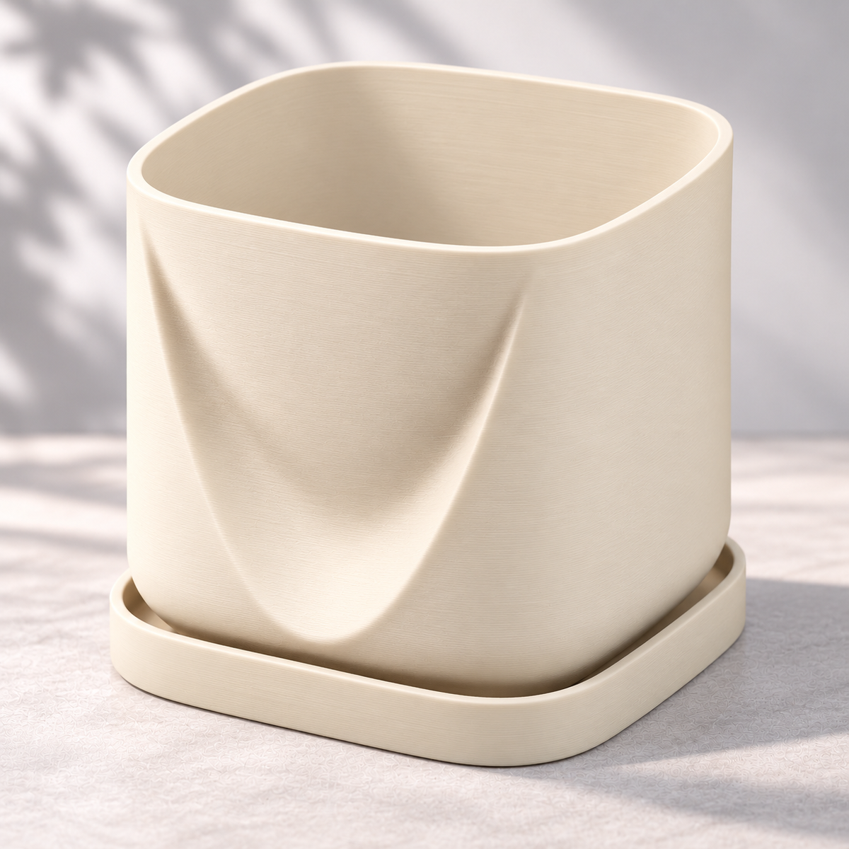 Cream White Drape planter on its matching tray, showing the folded front and softly squared opening.
