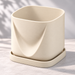 Cream White Drape planter on its matching tray, showing the folded front and softly squared opening.