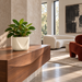 Cream White Drape planter with foliage on a walnut console in a sunlit designer living room.
