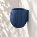 Empty navy Duoro wall planter mounted against a light wall, showing the curved body and rear mounting plate.