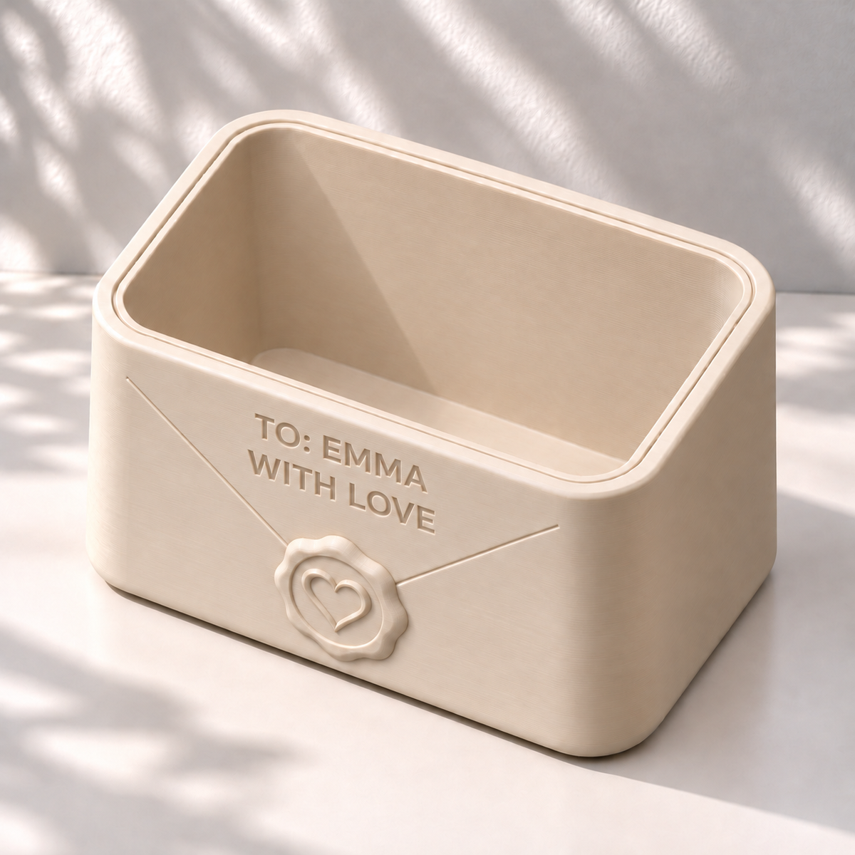 Top angled view of a cream Envio planter with a heart seal and the message TO: EMMA / WITH LOVE.