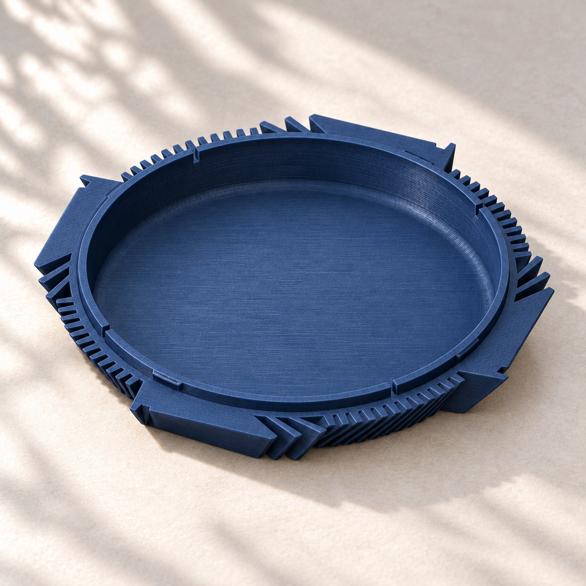 Removable navy blue Fano water collector with raised sides and a sculptural outer edge.