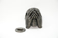 Front view of a sculptural face wall planter shown with its separate wall mounting plate