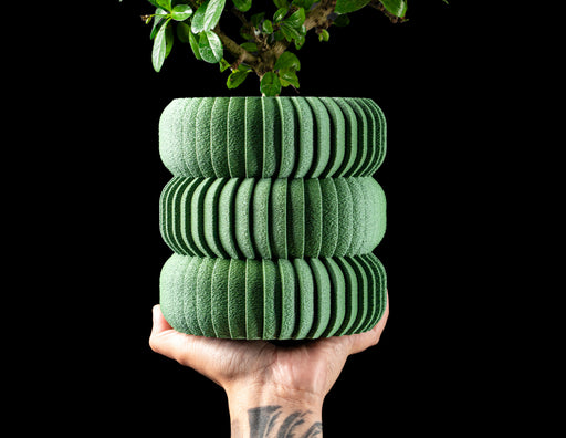 Koro ribbed LUX planter with plant, styled with multiple planters