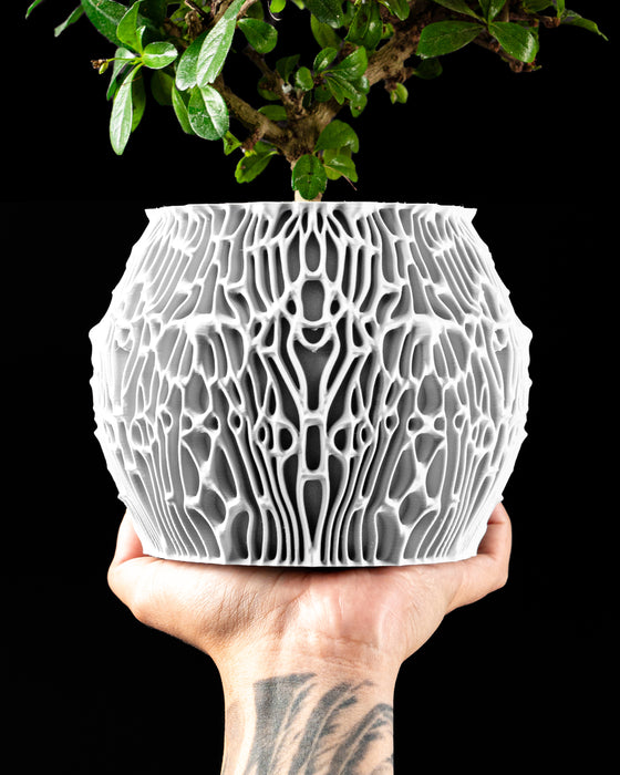 Nexis round planter with smooth inner vessel and irregular cellular ribs