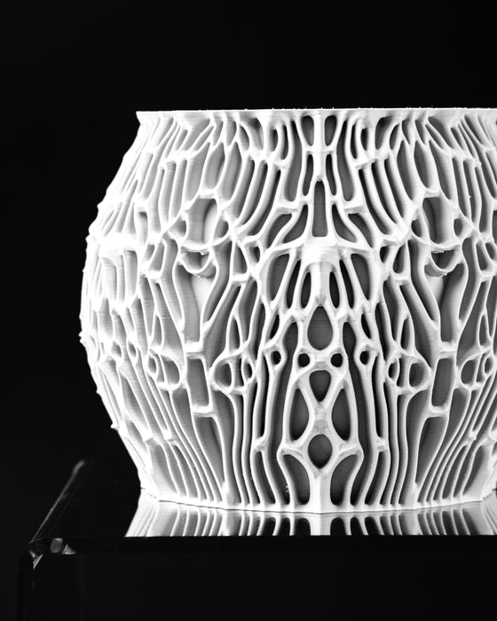 Angled view of Nexis sculptural planter with organic cellular wall pattern