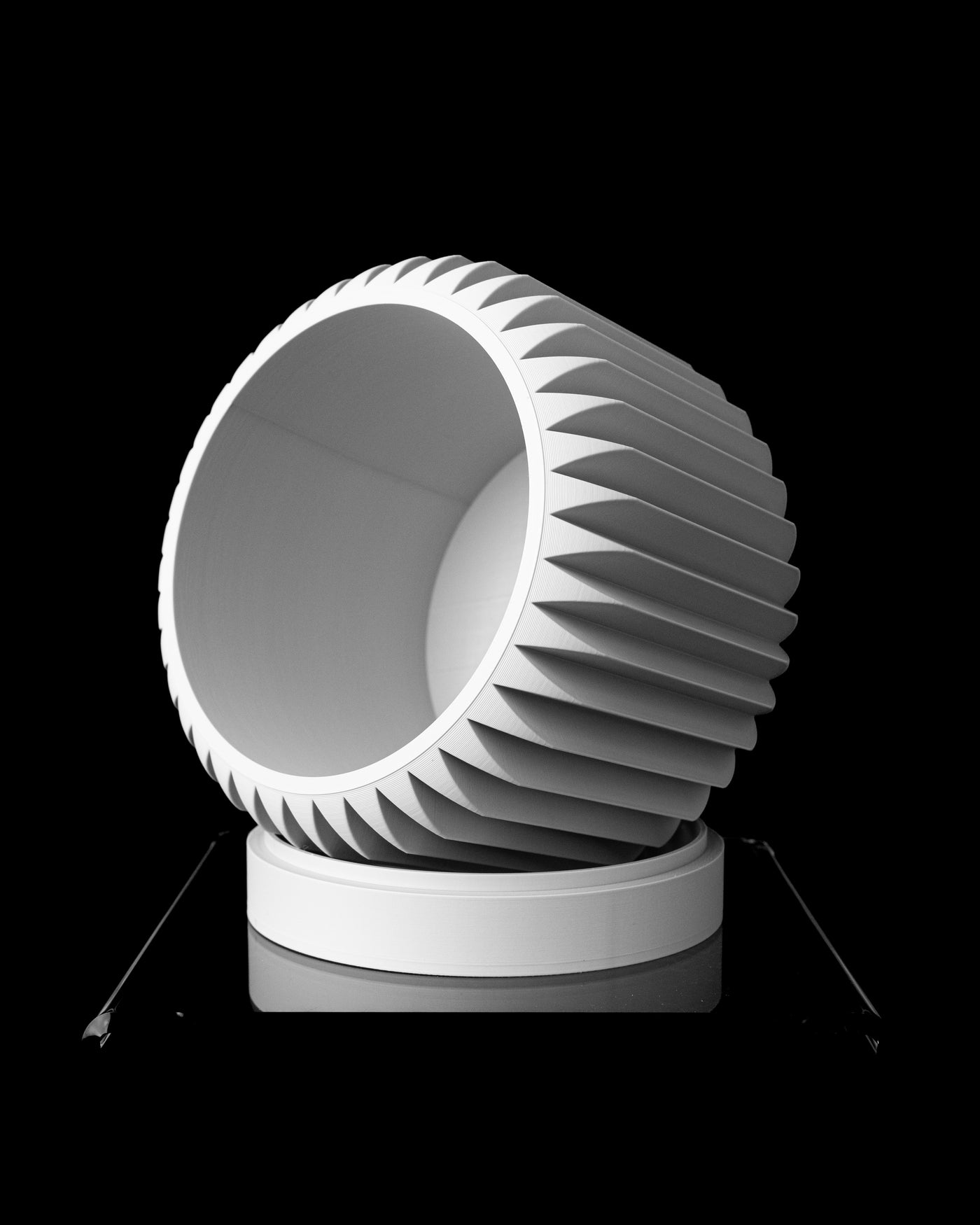 Nila ribbed planter tilted view showing rounded body and low pedestal base
