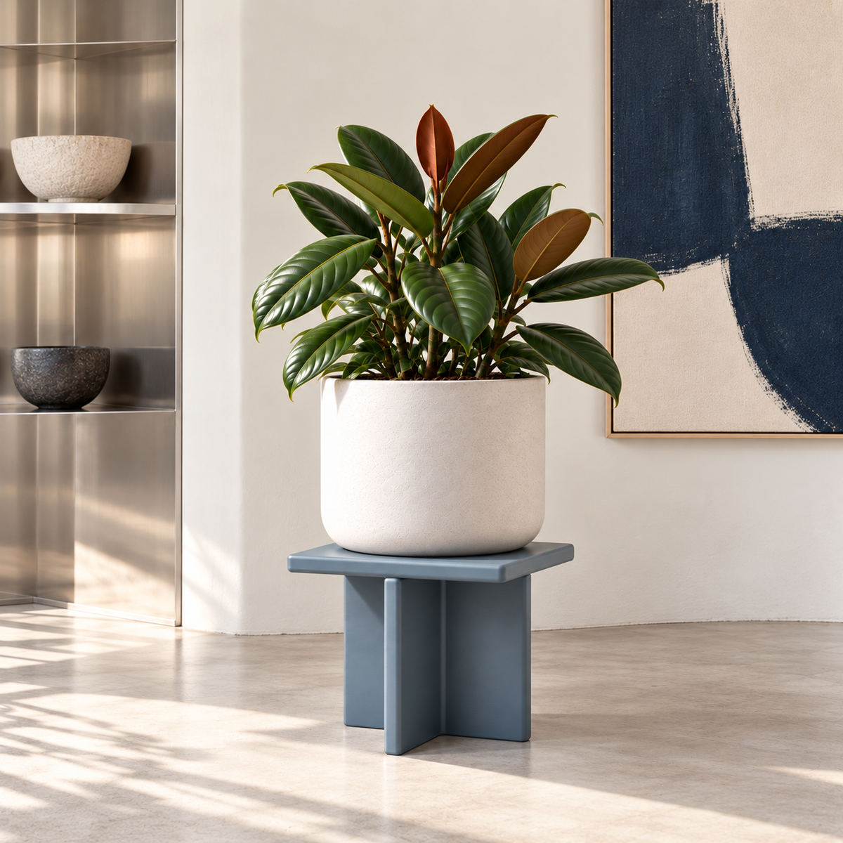 Grey-blue Plane plant stand supporting a white planter and rubber plant in a contemporary interior