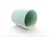 Tero plant stand shown on its side with hollow interior and ribbed outer surface in light green
