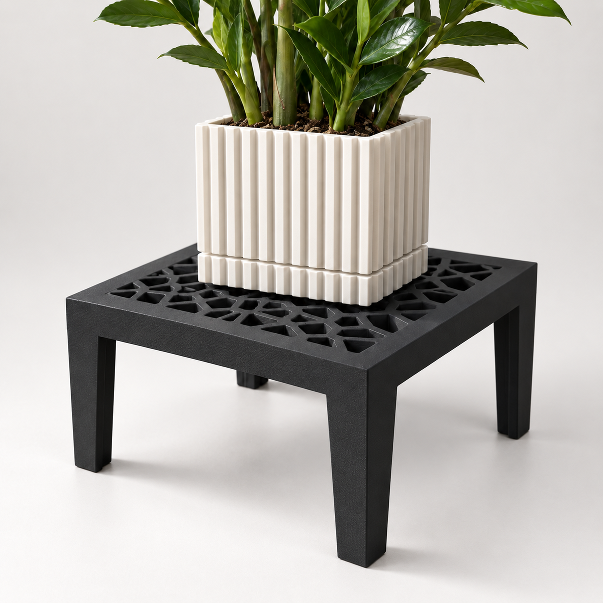 Black Grid Square plant stand with an open lattice top and four legs supporting a cream square pot.