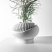 Front angled view displaying stylish sculptural oval planter pot with smooth layered geometric texture, tilted modern decorative flower pot, contemporary indoor succulent planter, artistic tabletop plant pot, unique 3D printed design