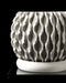 Angled top-down view of a 3D printed planter with a hollow cylindrical cavity for soil placement, set atop a contrasting open lattice foundation. The rough-grained vertical walls of the container rise in clean geometry, while the base's geometric cutouts provide both visual lightness and physical support. This modern planter balances engineering and artistry, making it ideal for elevating greenery with a futuristic yet natural silhouette.