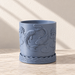 Empty blue Coraline planter with raised fish, aquatic leaves and a wave-patterned lower base.