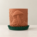 Myco indoor planter showing two-color mushroom and botanical surface details across the design