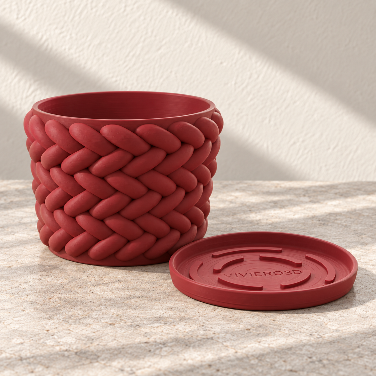 Upright empty red Braido planter beside its matching removable drainage tray.