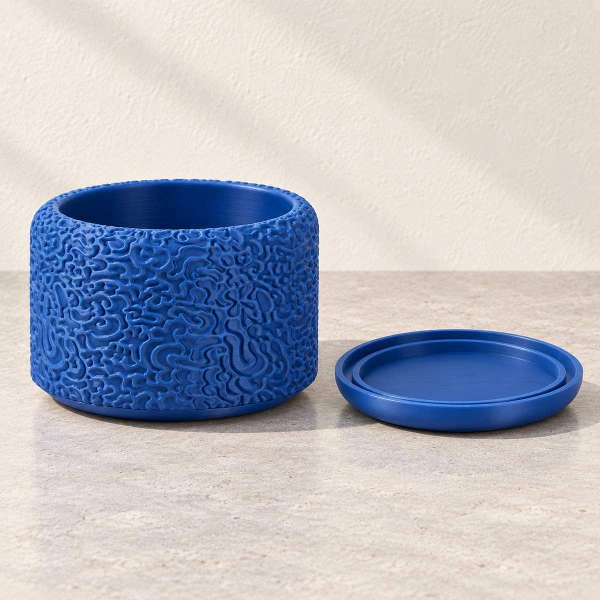 Drift decorative indoor planter featuring flowing layered surface texture