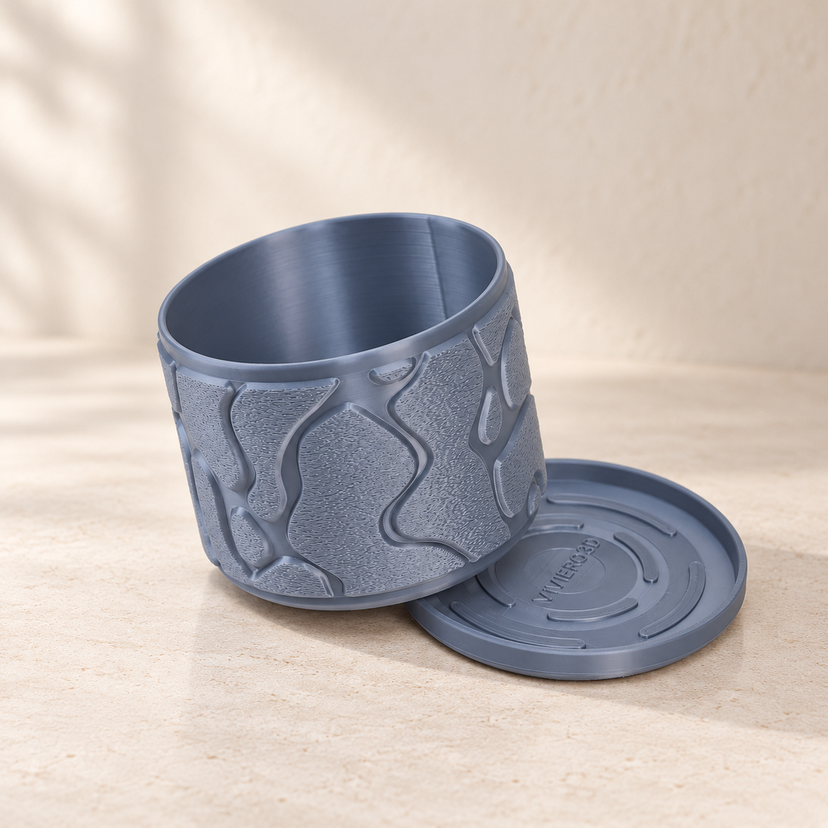 Close view of Flow decorative planter with flowing contour relief and rounded rim