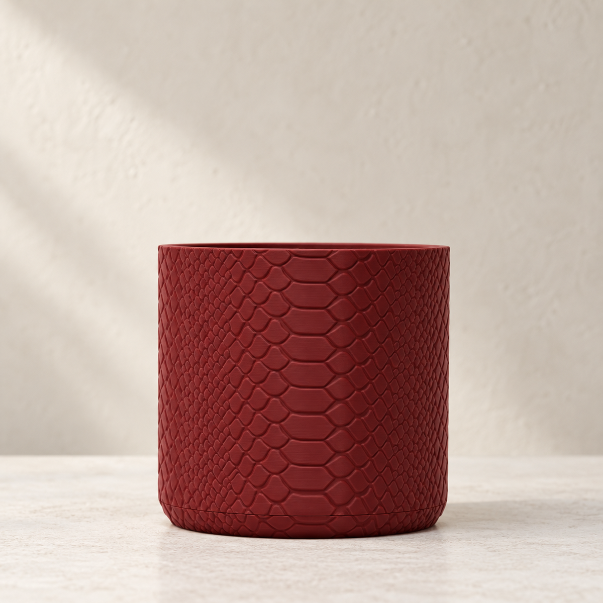 Serpen indoor planter showing subtle snake-scale texture across the design