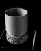 close-up of lower section of a 3D printed planter with detailed cutout base structure, showing complex polygonal openings and smooth connector ring, top body features fine-grain vertical texture, color balanced between soft charcoal and graphite, printed with sustainable material, indoor-friendly, decorative and lightweight, modern home planter, sculptural plant pot, black planter, gifts for modern homeowners, 3d printed item, planters and pots, personalised decor, flower pots