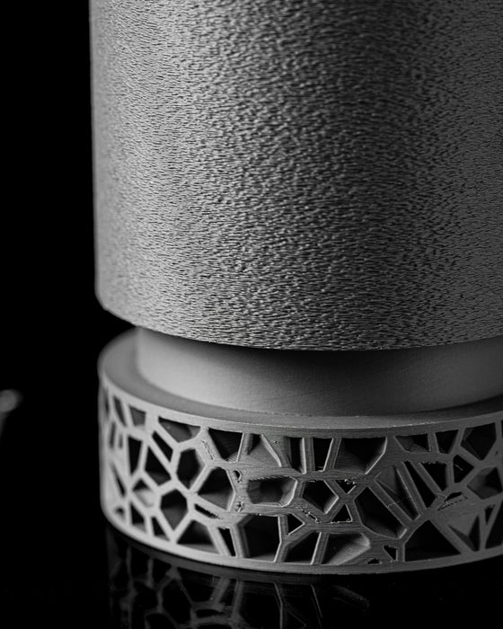 elevated side view of modern planter held in hand, showing scale and lightweight feel of 3D-printed object, textured matte pot and parametric ring base merge functionality with design, neutral dark tone blends with minimalist interiors, gift for designers or plant lovers, modern planter pot, unique flower pot, housewarming gift, college gifts, sustainable 3d printed decor, personalised gift idea, textured finish container, large planter, sculptural decor piece, hand-sized architectural planter