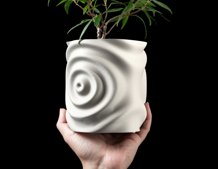 top perspective showing open rim of white planter with flowing ripple pattern, interior cavity spacious and smooth, walls undulate with radial energy as if reacting to water movement, fine texture reveals additive layer-by-layer construction, minimalist sculptur