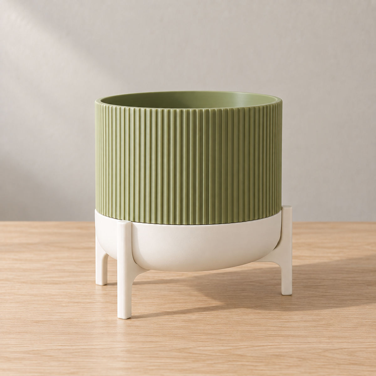 Empty green Rialto ribbed planter seated in a white rounded base and open legged frame.