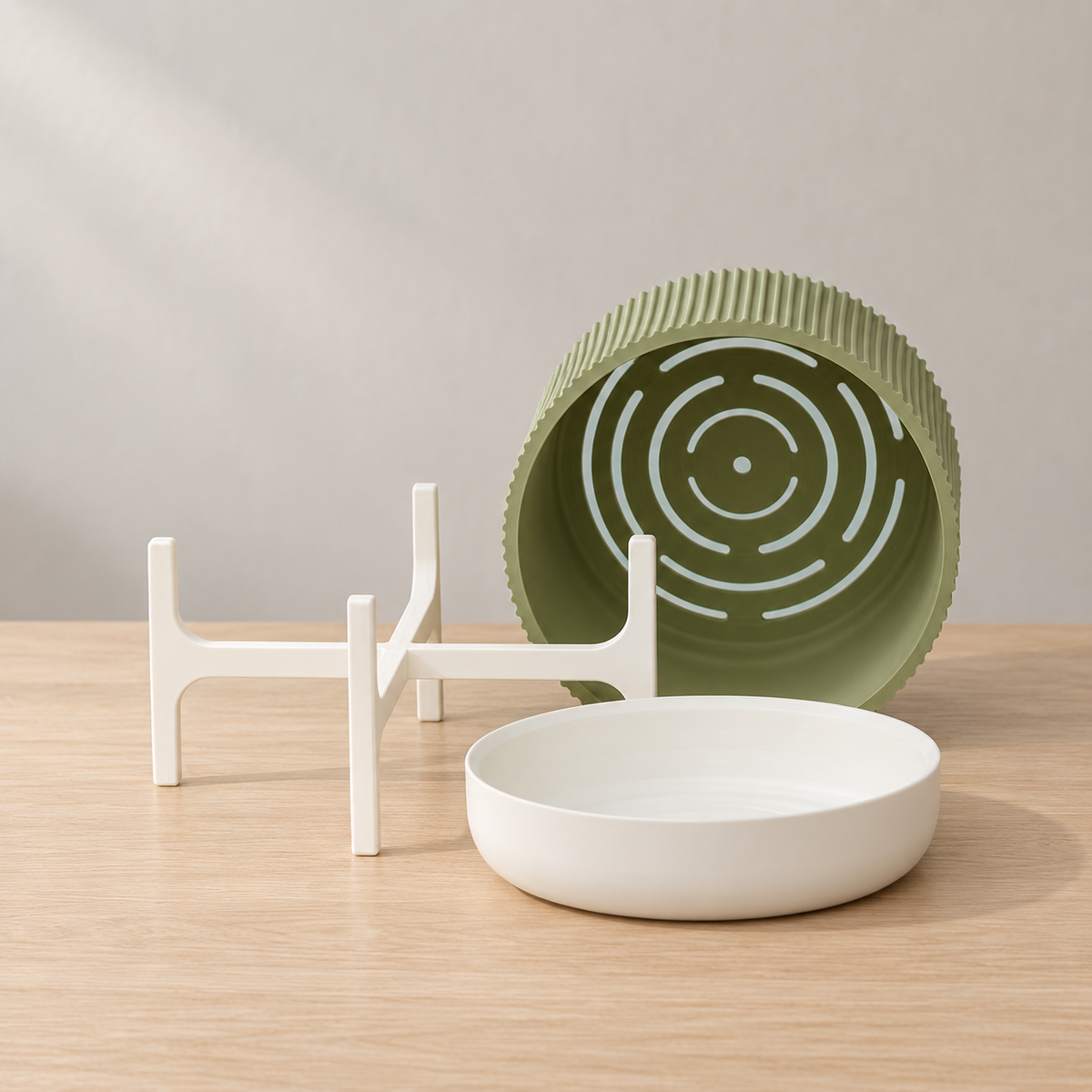 Rialto planter parts showing the slotted green pot bottom, separate white bowl and legged frame.