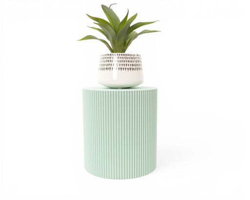 Tero plant stand in light green with white planter and indoor plant displayed on top