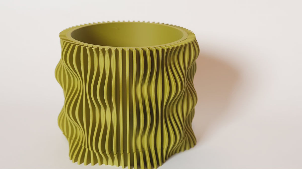 video olive green Muxel planter with a flowing wavy texture