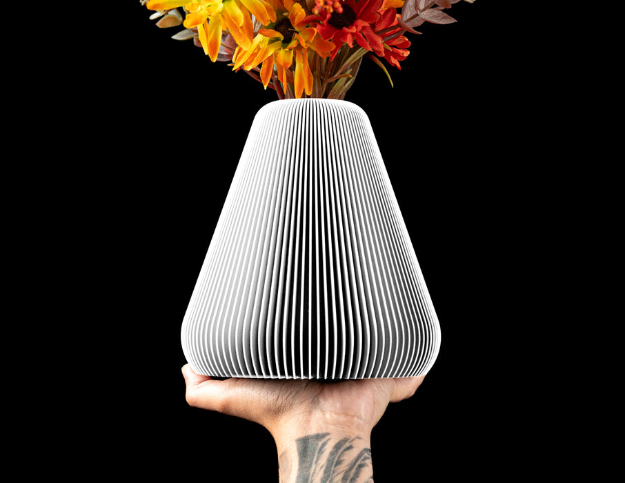 Rillan tapered flower vase with fine vertical ribs and floral stems